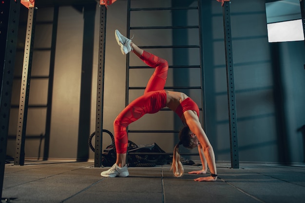 Young muscular woman practicing in gym