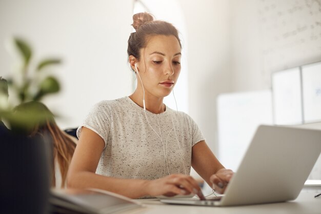 Young music producer using a laptop to compose an upbeat hit. Freelance editor browsing through tons of text to find the perfect screenplay.