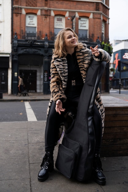 Free photo young musician singing around the city