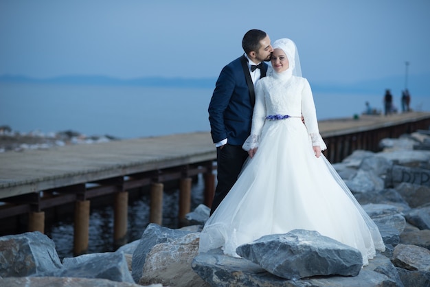 Free photo young muslim bride and groom wedding photos