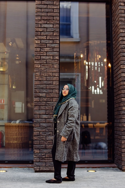 거리에서 사진을 찍는 젊은 이슬람 여성