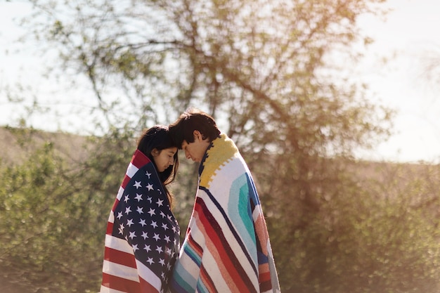 Young native american couple with usa flag