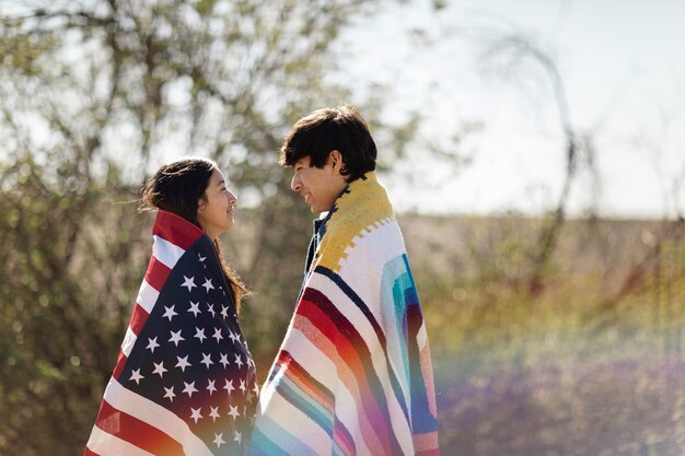 Young native american couple with usa flag