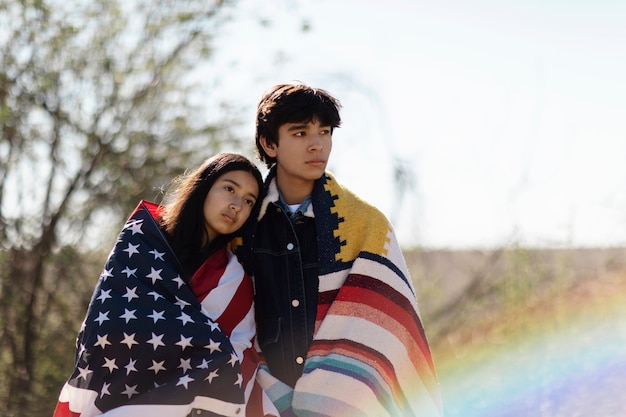 Young native american couple with usa flag
