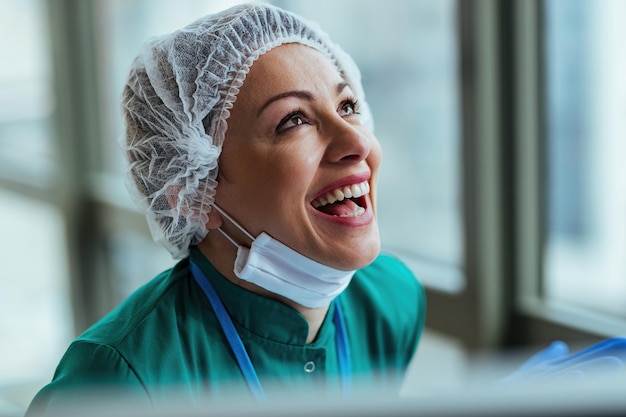 Free photo young nurse feeling happy about good news she has received while working at the hospital