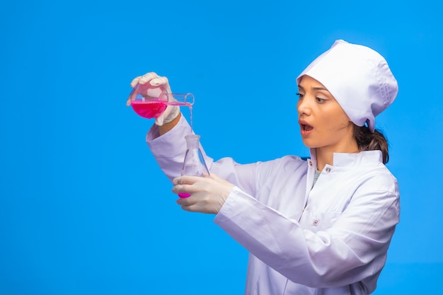 Young nurse makes chemical reaction and gets surprized.