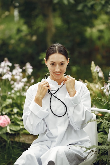 Young nurse in outdoor. Woman doctor. Image for advertising scientific developments in the food and medical industry.