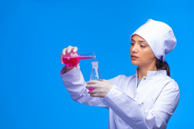 Young nurse in white uniform checks biological reaction