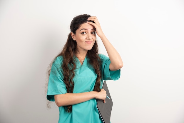 Young nurse with clipboard and pencil.