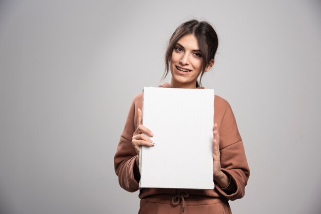 Young painter showing empty canvas