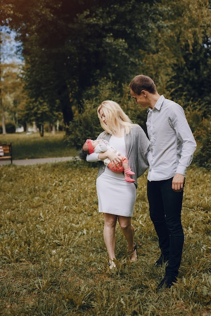 Free photo young parents looking at their baby