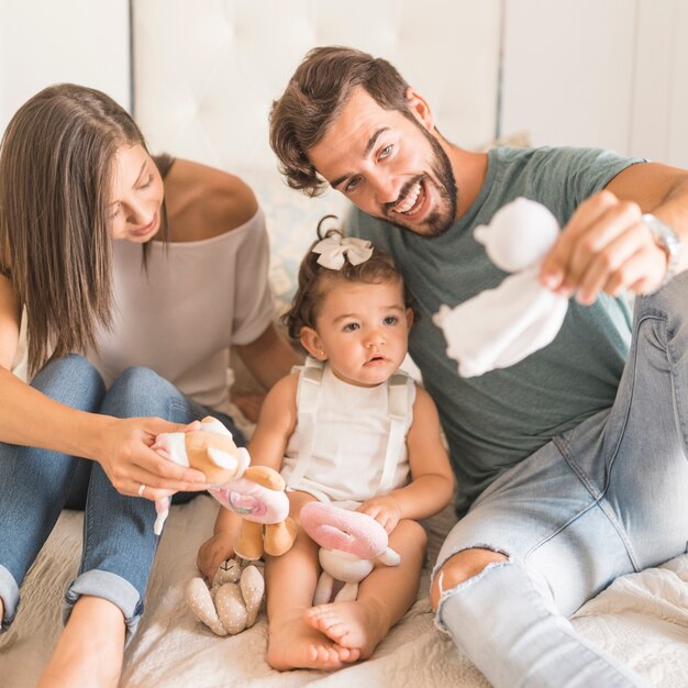 Young parents playing with girl