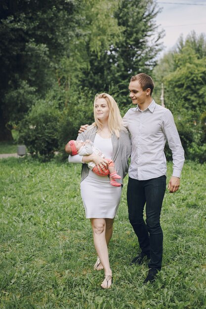 Young parents with a baby walking