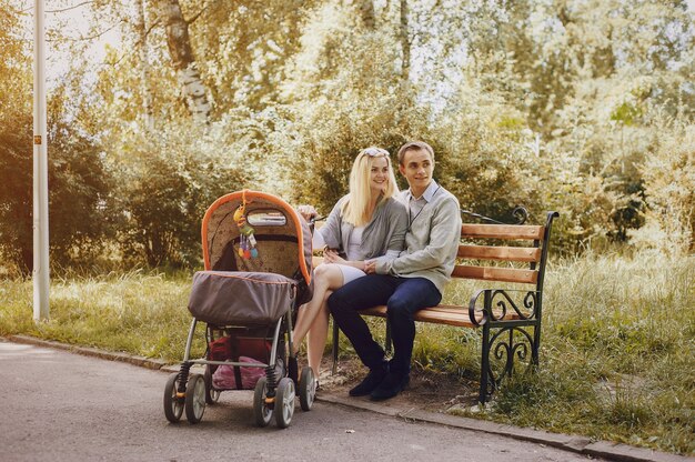 Young parents with stroller enjoying a day in the park