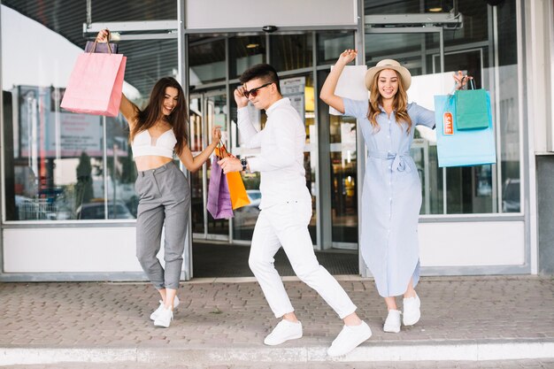 Young people dancing after shopping