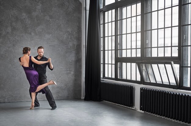 young people dancing tango in a studio
