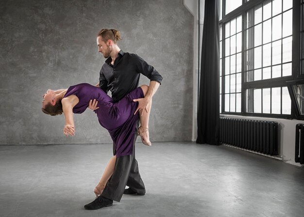 Young people dancing tango in a studio