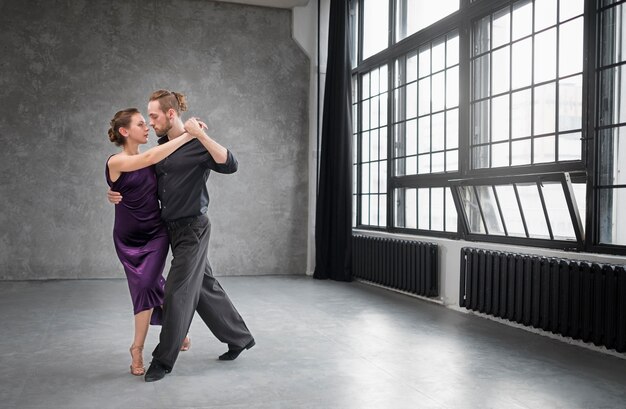 Young people dancing tango in a studio