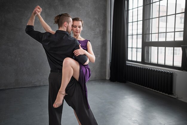 Young people dancing tango in a studio