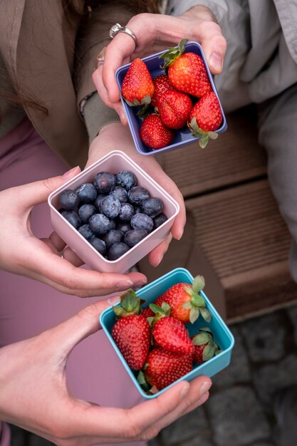 Young people eating berries in the street