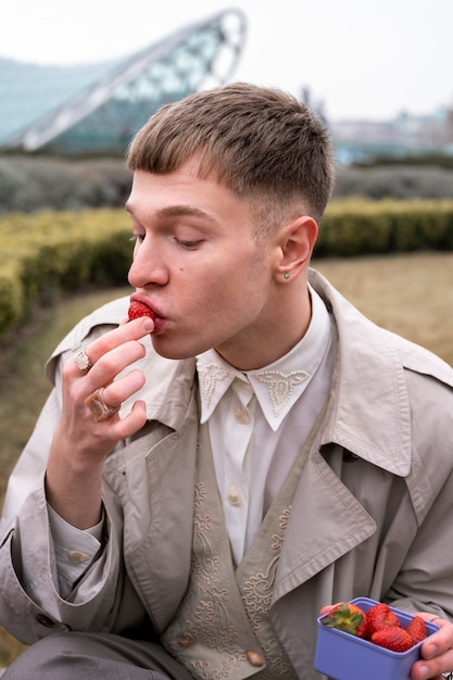 Young people eating berries in the street