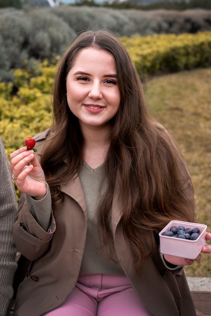 Young people eating berries in the street