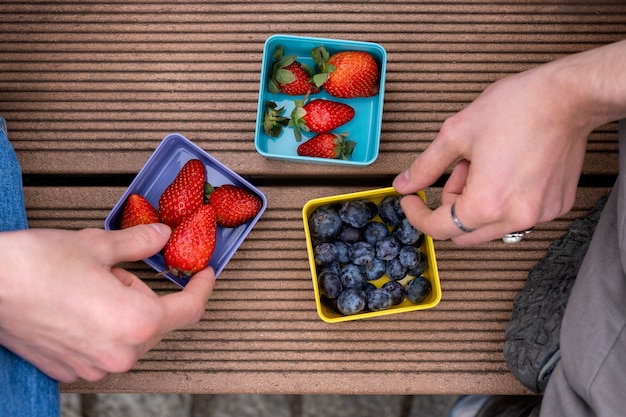 Young people eating berries in the street