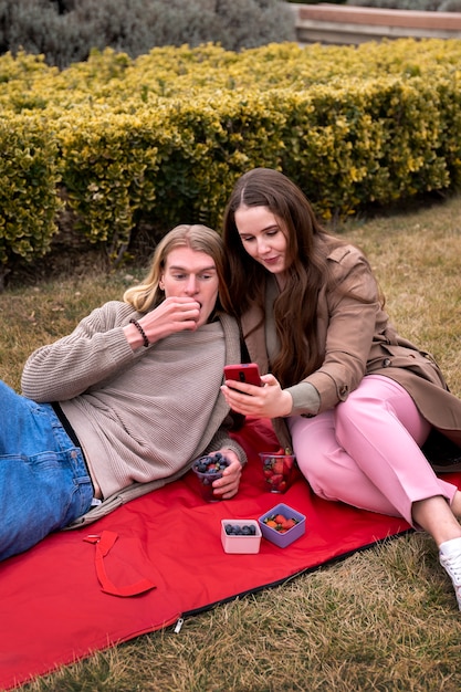 Free photo young people eating berries in the street