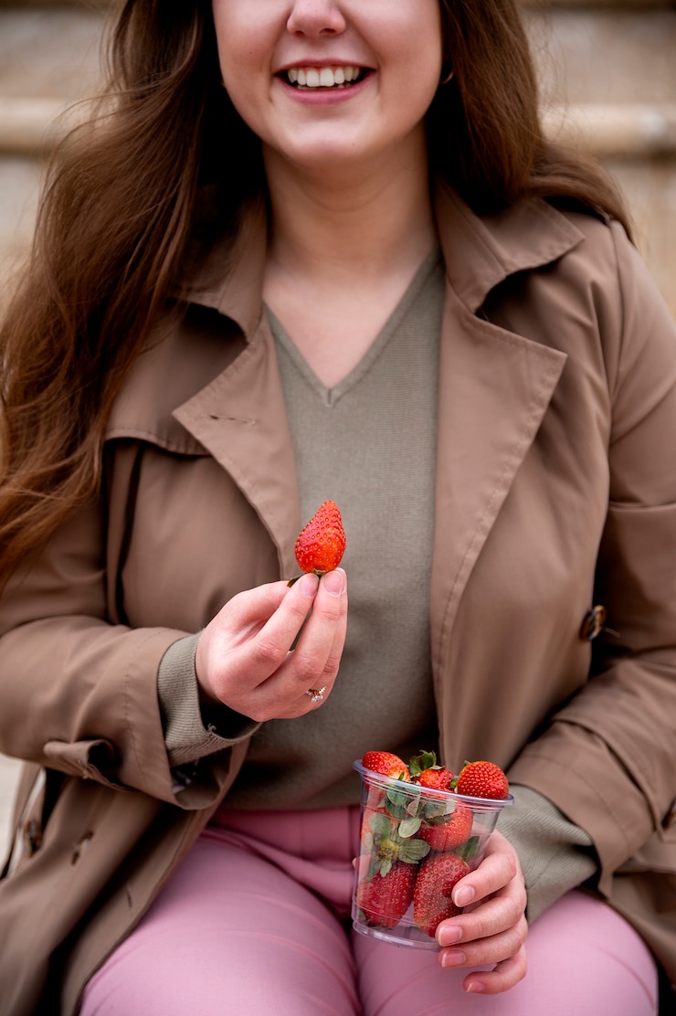 Free Photo young people eating berries in the street