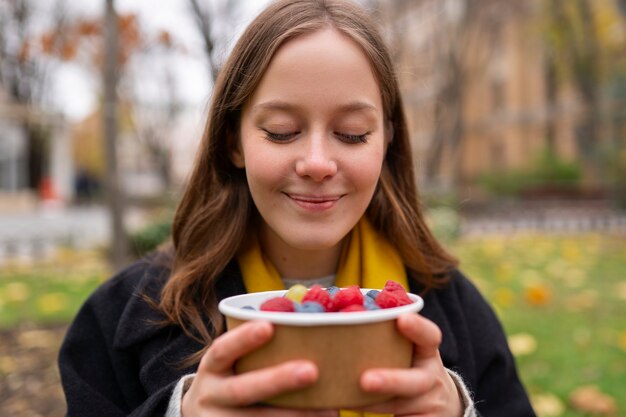 Young people eating berries in the street