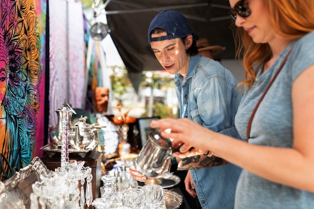 Young people at flea market side view