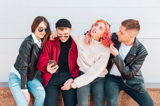 Young people having fun while taking selfie on smartphone