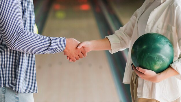 Young people holding bowling balls