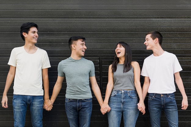 Free photo young people holding hands together