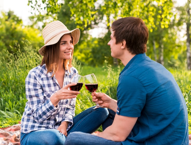 Young people in love having date outside with wineglasses