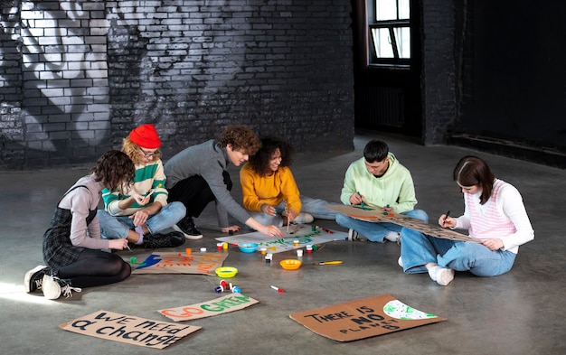 Young people making banners full shot