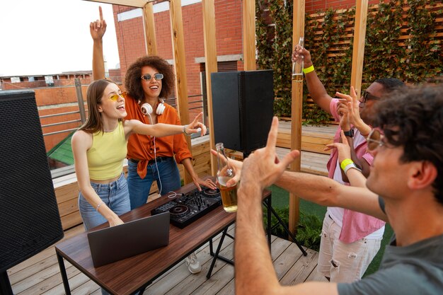 Young people partying together side view