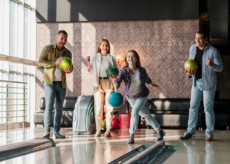 Free Photo young people playing bowling