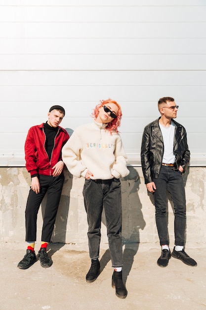 Young people posing while standing on street