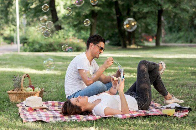 Young people resting on a blanket at picnic