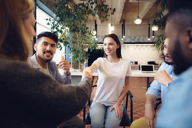 Free photo young people sitting in a circle and having a discussion