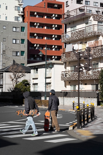 Free photo young people skateboarding in japan