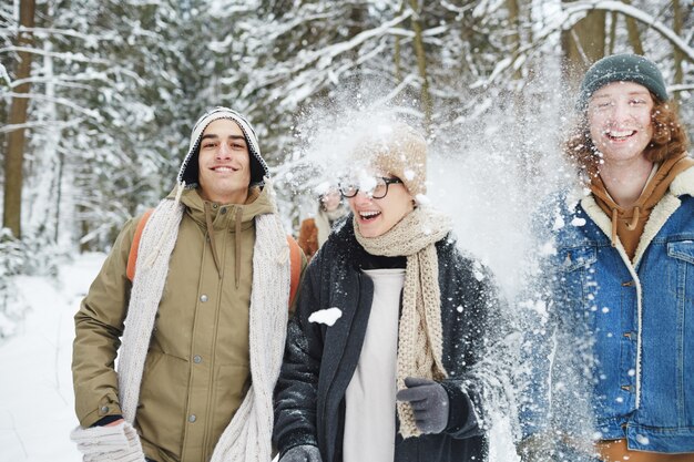 Young People in Snowy Forest