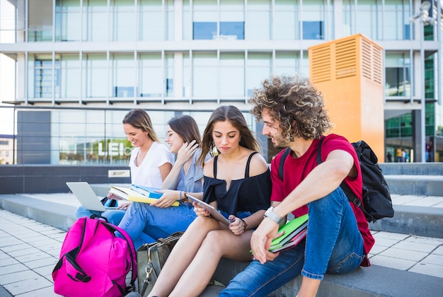 Young people studying on street