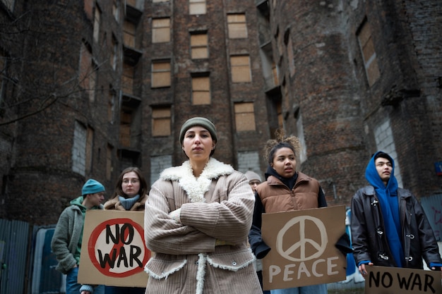 Free photo young people taking part of anti war protest