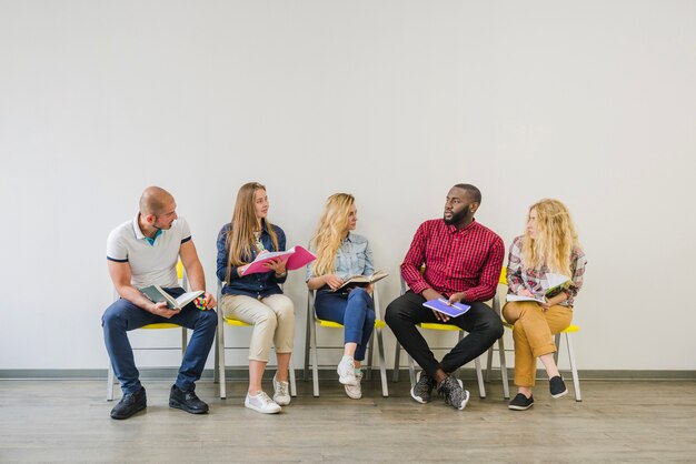 Young people with notes on chairs