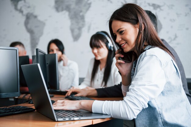 Young people working in the call center. New deals is coming