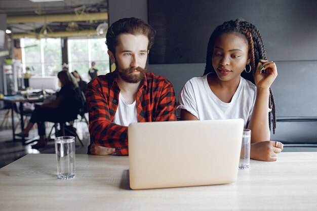 Young people working together and use the laptop