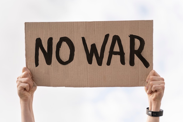 Young person holding anti war protest sign