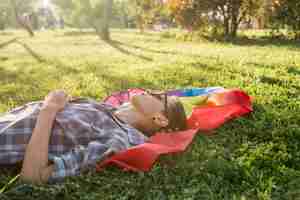 Free photo young person lying on rainbow flag